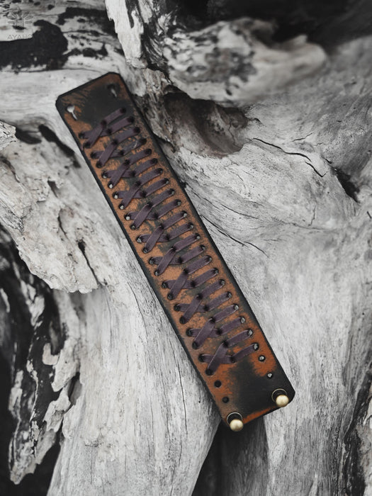 Handcrafted rust-brown buffalo leather bracelet featuring a triple-loop infinity symbol, representing the connection between body, spirit, and nature.