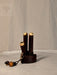 Wooden incense holder with gold accents on a neutral background